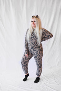 Model wearing a women's leopard print lounge set with long sleeves and pants.