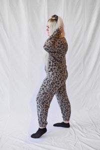 Model wearing a women's leopard print lounge set with long sleeves and pants.