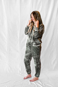 Model wearing women's green tie dye long sleeve hoodie and sweatpants loungewear set.