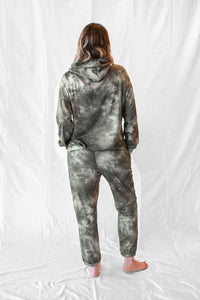 Model wearing women's green tie dye long sleeve hoodie and sweatpants loungewear set.