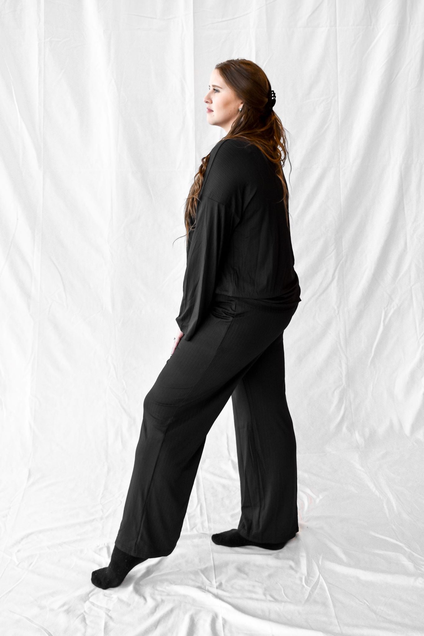 Model wearing women's loose luxury all black loungewear set.