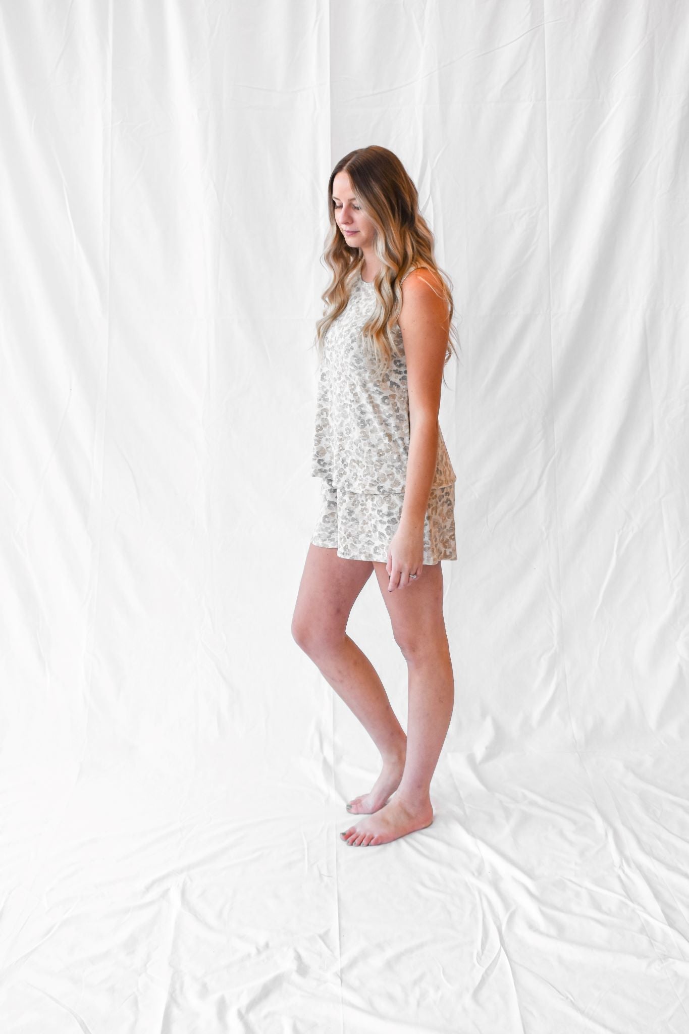 Model wearing women's tan leopard tank and shorts loungewear set.