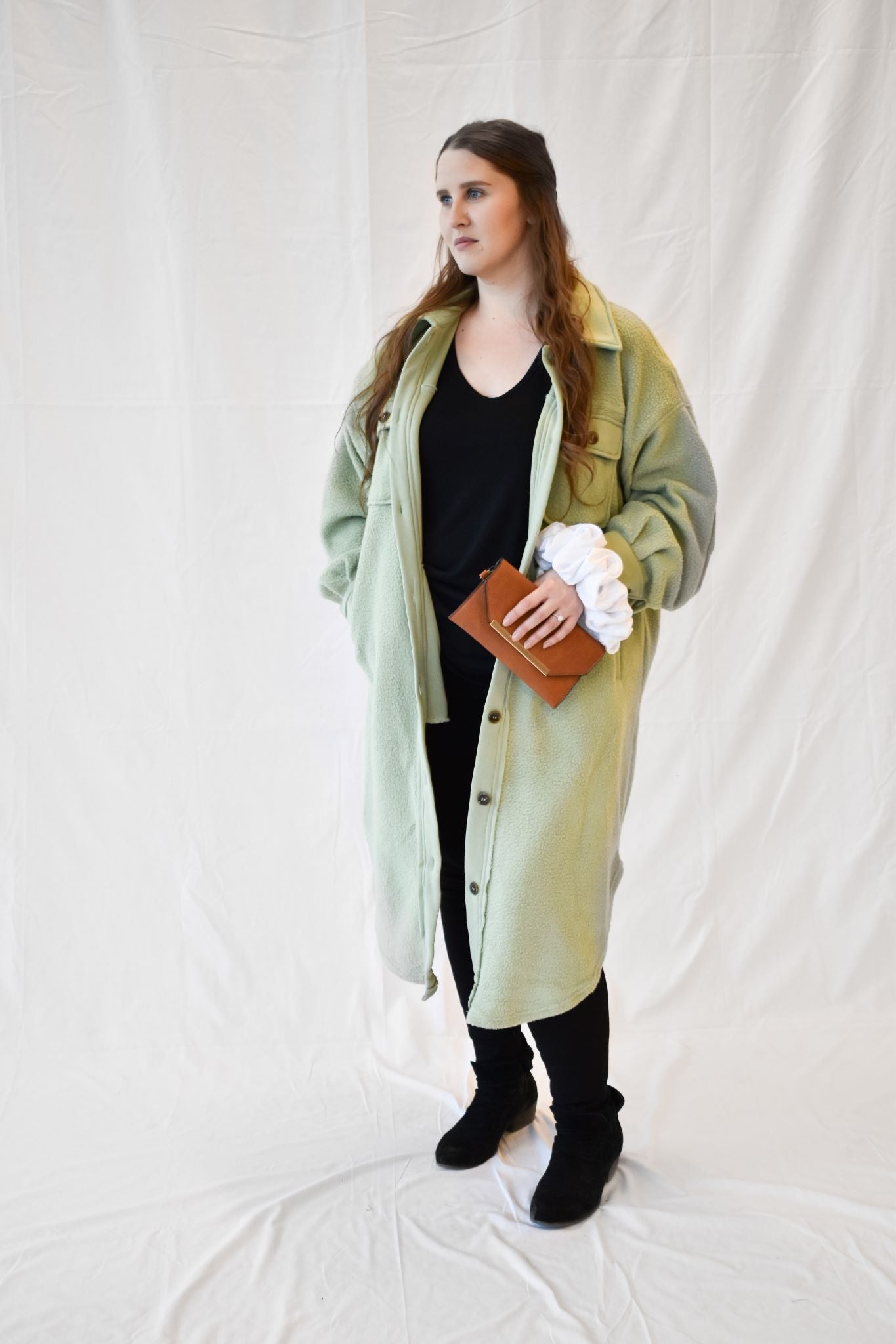 Model wearing women's sage green long fleece jacket.