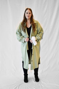 Model wearing women's sage green long fleece jacket.