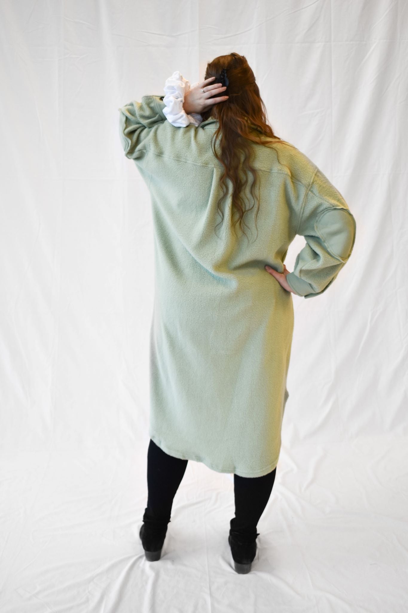 Model wearing women's sage green long fleece jacket.