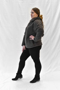 Model wearing women's grey sherpa half zip sweater with long sleeves.