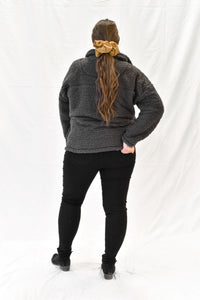 Model wearing women's grey sherpa half zip sweater with long sleeves.