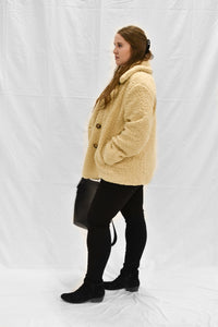 Model wearing women's tan colored oversized peacoat.