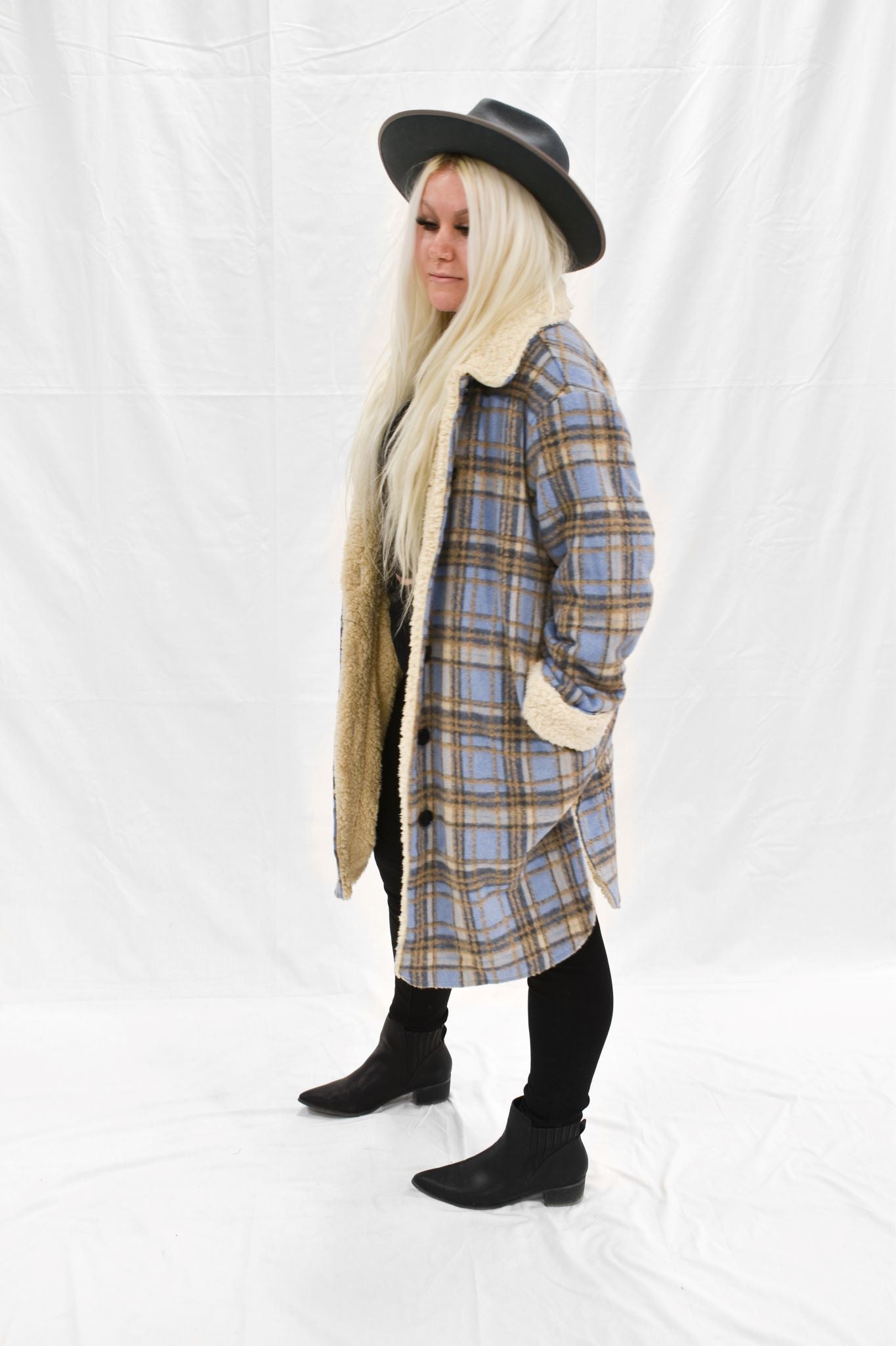 Model wearing women's tan and blue plaid faux fur lined jacket.