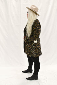 Model wearing a women's leopard print fur blazer coat.