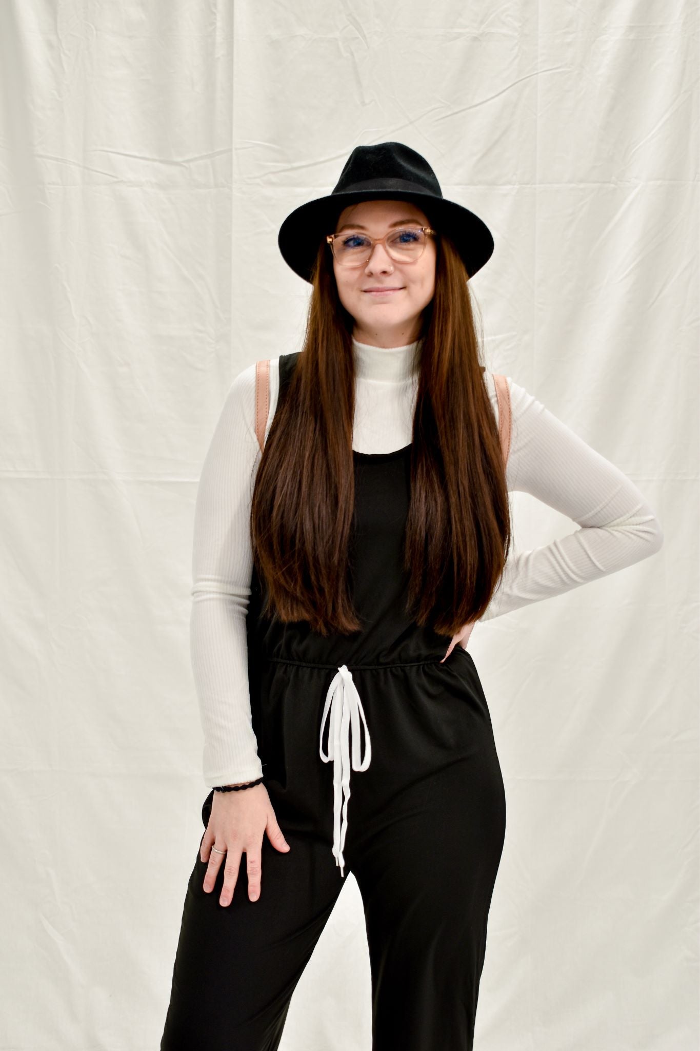 Model wearing women's white velvet ribbed mock neck cropped top with long sleeves.