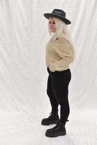 Model wearing women's tan/multicolored V-neck knit sweater.