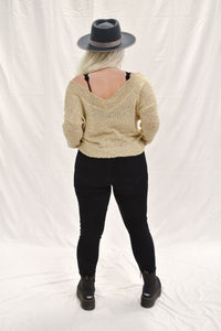 Model wearing women's tan/multicolored V-neck knit sweater.