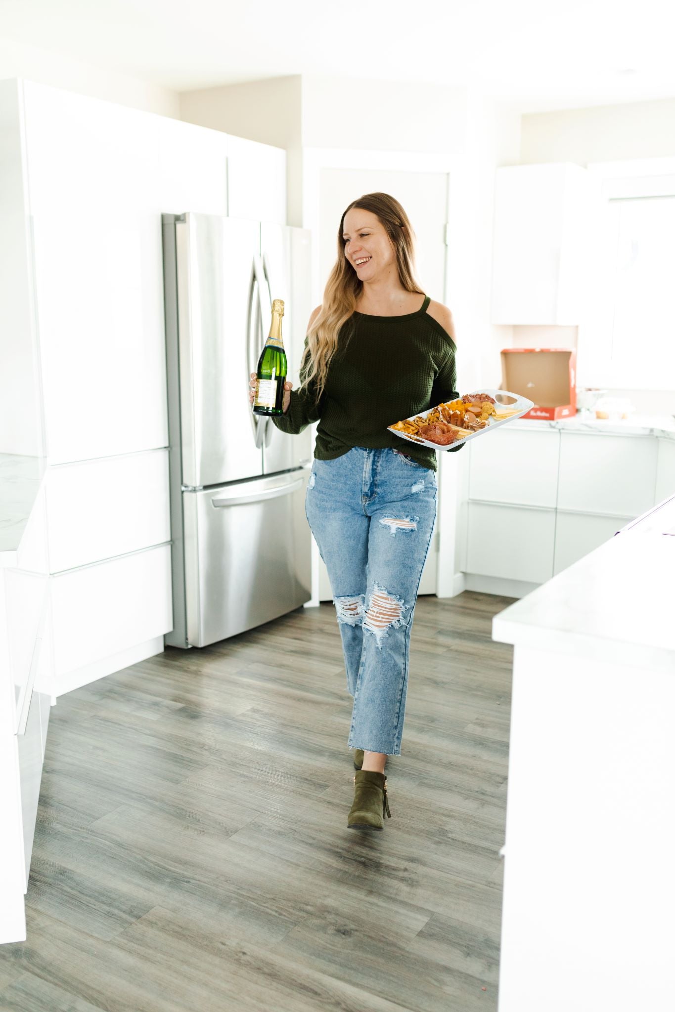 Model wearing women's light wash high waisted straight jeans with cropped bottoms.