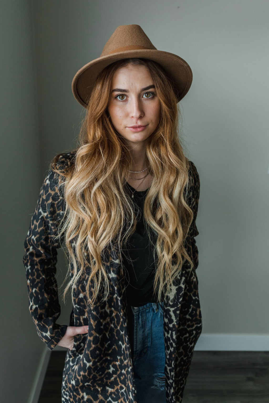 Model wearing a women's leopard print fur blazer coat.