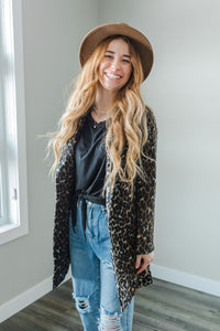 Model wearing a women's leopard print fur blazer coat.