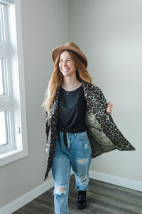 Model wearing a women's leopard print fur blazer coat.