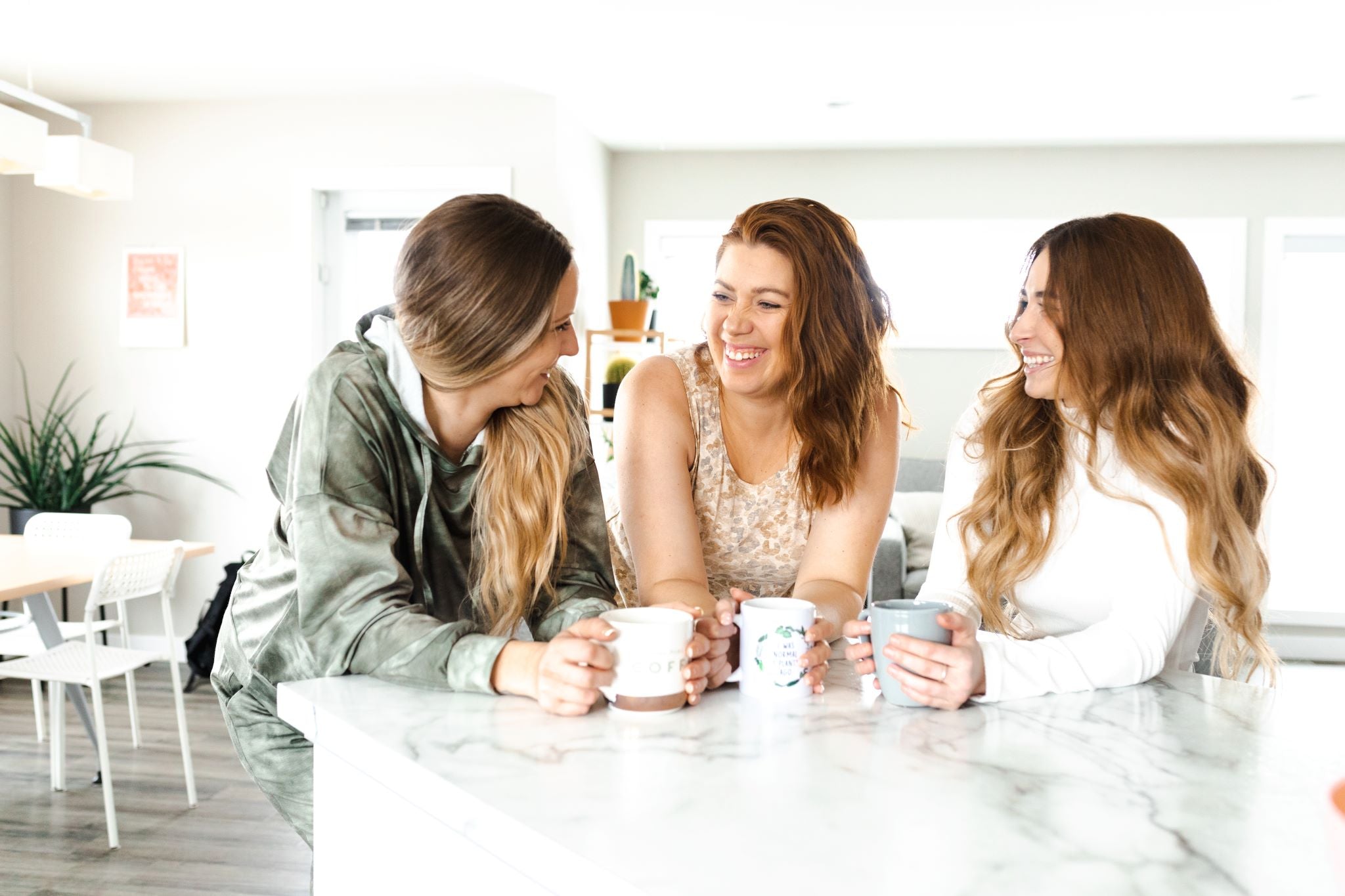 Woman enjoying time with friends while wearing tan leopard tank and shorts loungewear set.