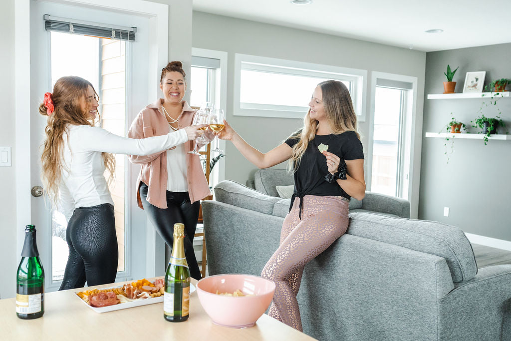 Model wearing women's shaping snake print faux leather leggings with friends.